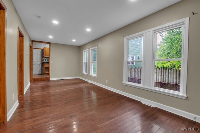 spare room featuring dark hardwood / wood-style flooring