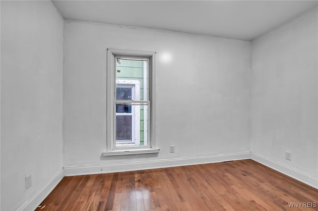 empty room with hardwood / wood-style floors