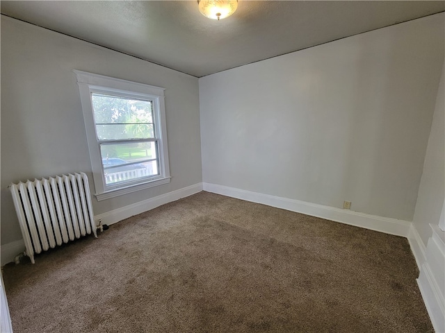 carpeted empty room with radiator