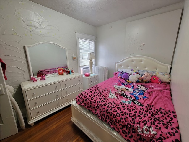 bedroom with dark wood-type flooring and a textured ceiling