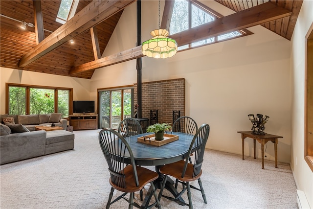 dining room featuring a wood stove, high vaulted ceiling, and light carpet