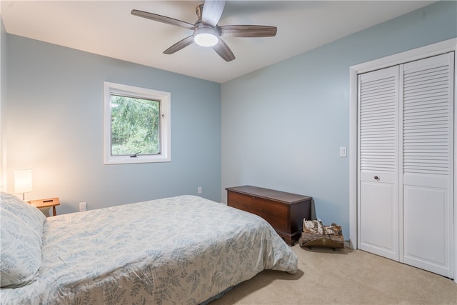 carpeted bedroom featuring a closet and ceiling fan