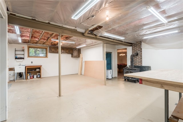 basement with sink and a wood stove