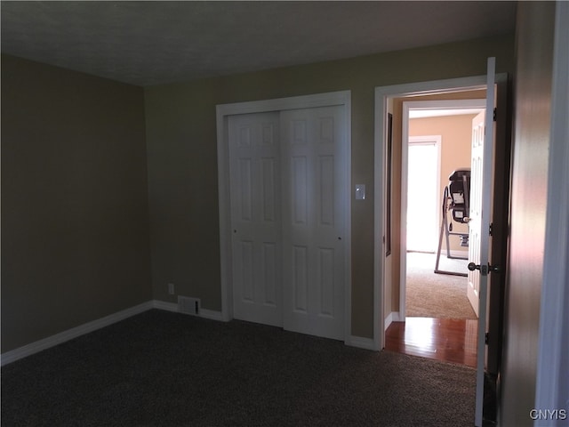 unfurnished bedroom with carpet flooring and a closet