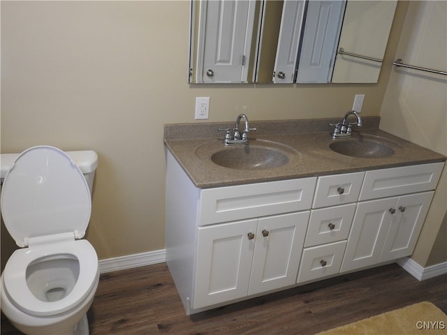 bathroom with vanity, toilet, and hardwood / wood-style flooring