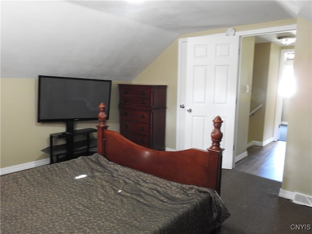 bedroom featuring hardwood / wood-style floors and vaulted ceiling