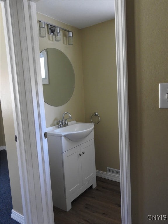 bathroom with vanity and hardwood / wood-style flooring