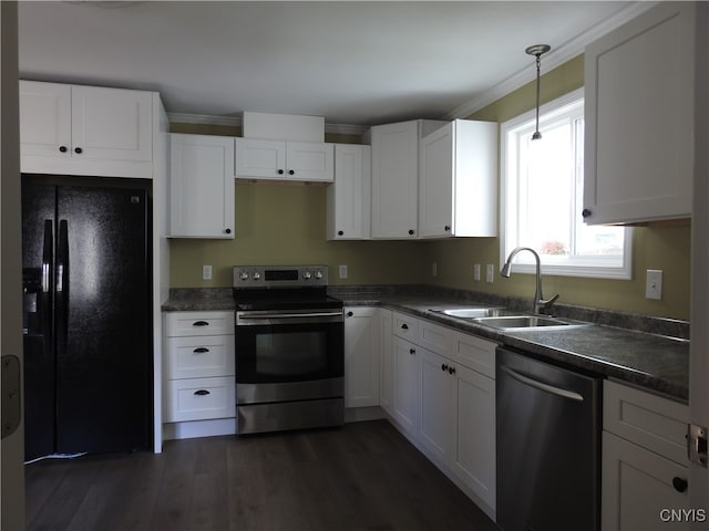 kitchen featuring white cabinetry, appliances with stainless steel finishes, sink, and decorative light fixtures