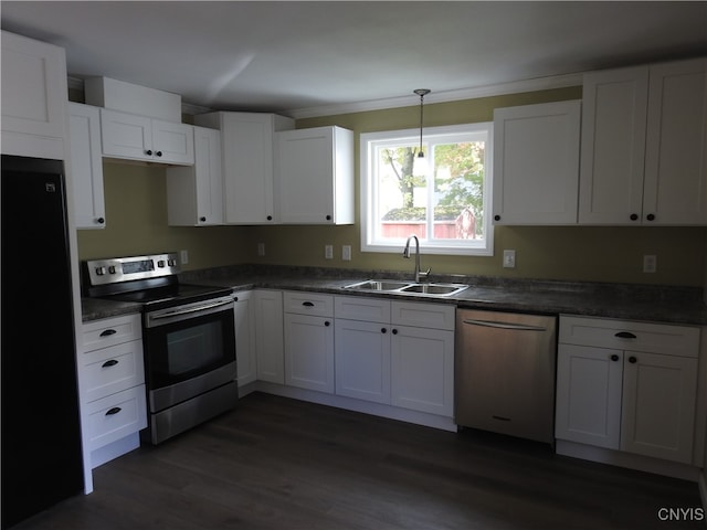 kitchen featuring stainless steel appliances, sink, pendant lighting, and white cabinets