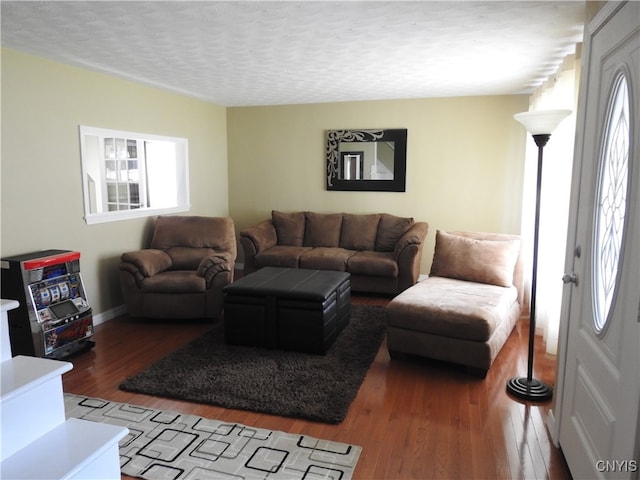 living room with hardwood / wood-style floors and a textured ceiling