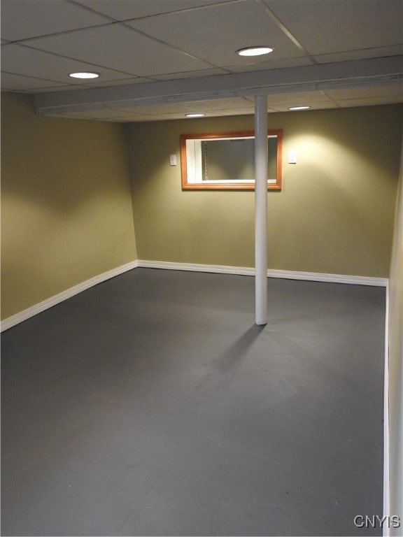 basement featuring a paneled ceiling