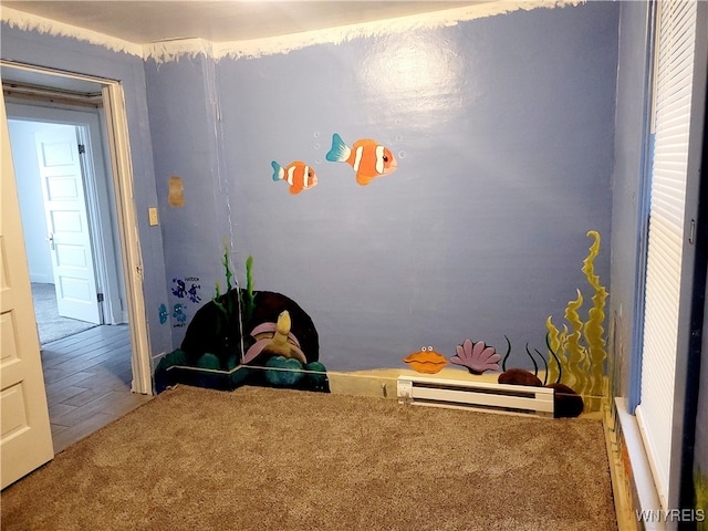 game room with wood-type flooring and a baseboard radiator