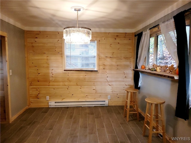 unfurnished dining area featuring dark wood-type flooring, a notable chandelier, a baseboard radiator, and wooden walls