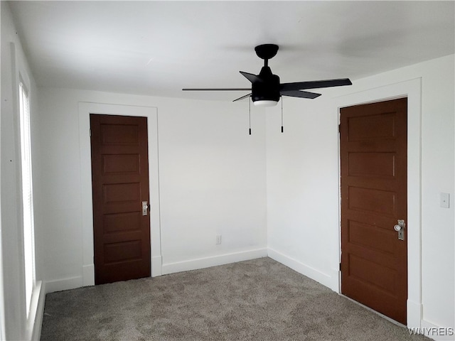 unfurnished room with ceiling fan and carpet floors