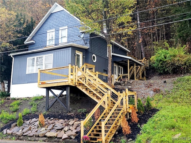 rear view of house featuring a deck