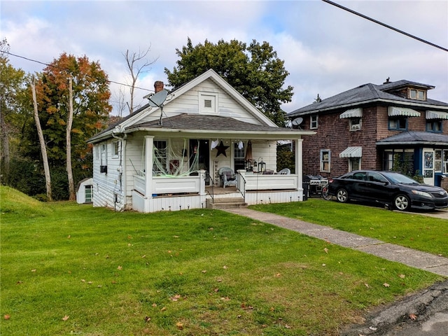 bungalow-style house with a front lawn and covered porch