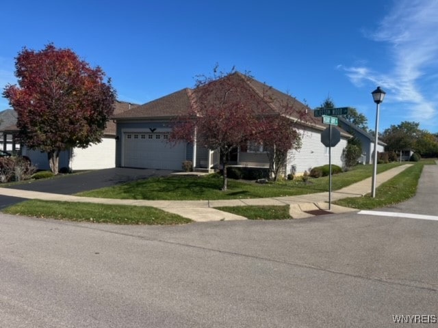 view of front of property with a front yard and a garage