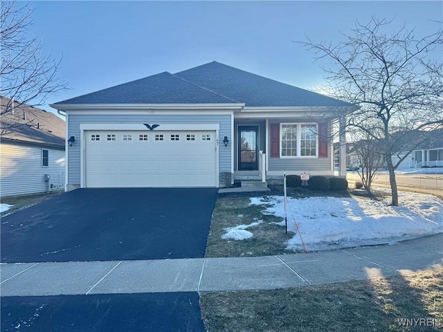 view of front of property with aphalt driveway, roof with shingles, and an attached garage