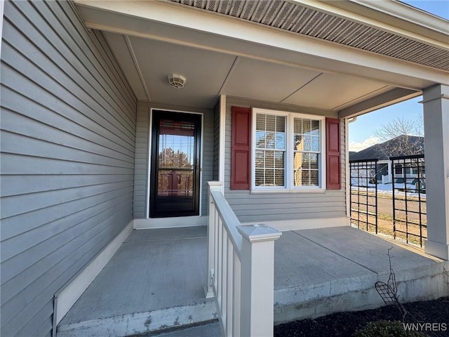 view of exterior entry featuring a porch