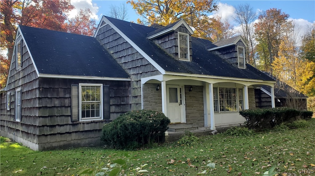 exterior space with a lawn and a porch