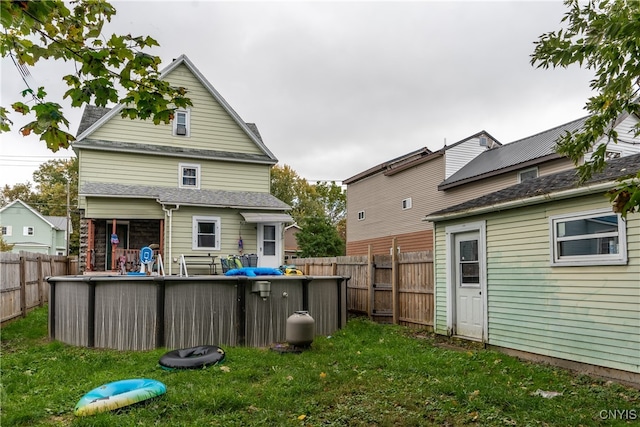 rear view of house with a lawn