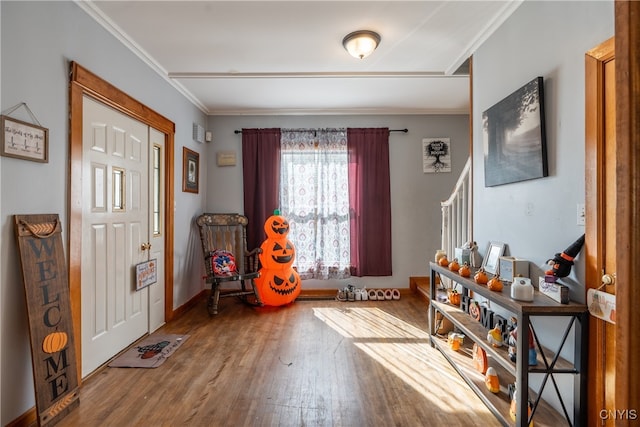 entryway featuring hardwood / wood-style flooring and ornamental molding