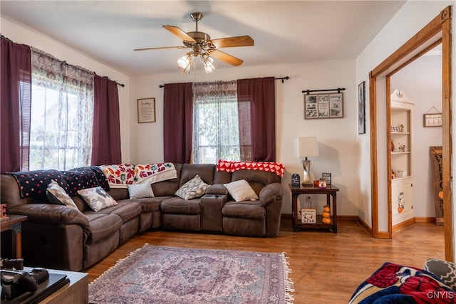 living room with hardwood / wood-style flooring and ceiling fan