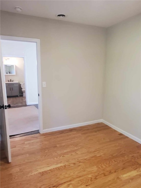 spare room featuring wood-type flooring