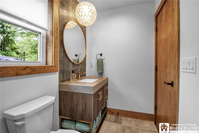 bathroom with vanity, toilet, and tile patterned floors