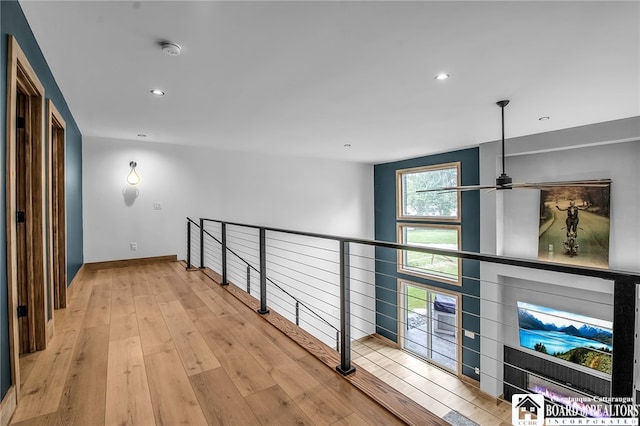 corridor with a wealth of natural light and light wood-type flooring