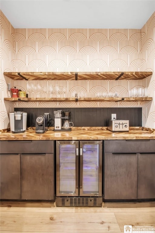 bar with wooden counters, refrigerator, and wine cooler