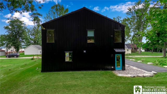 view of property exterior with a yard