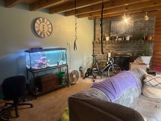 carpeted living room featuring beamed ceiling and a fireplace