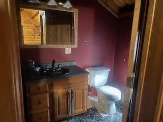 bathroom featuring toilet and vanity