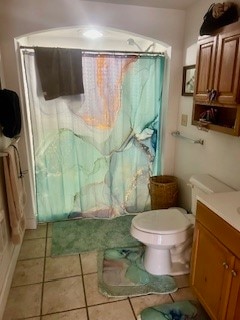 bathroom with vanity, toilet, and tile patterned flooring