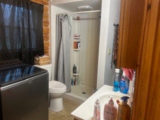 bathroom with toilet and walk in shower