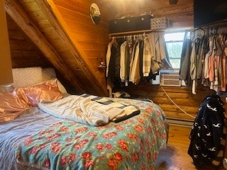 bedroom with lofted ceiling and dark hardwood / wood-style floors