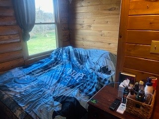 bedroom with wooden walls