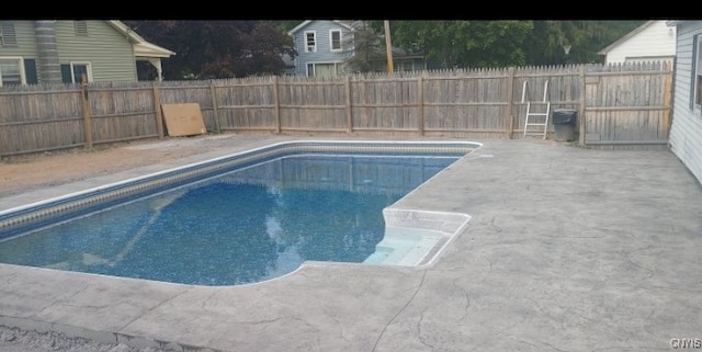 view of swimming pool with a patio area and a fenced backyard