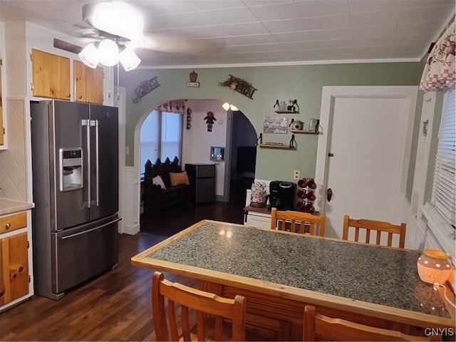 kitchen with ceiling fan, high end refrigerator, arched walkways, and crown molding