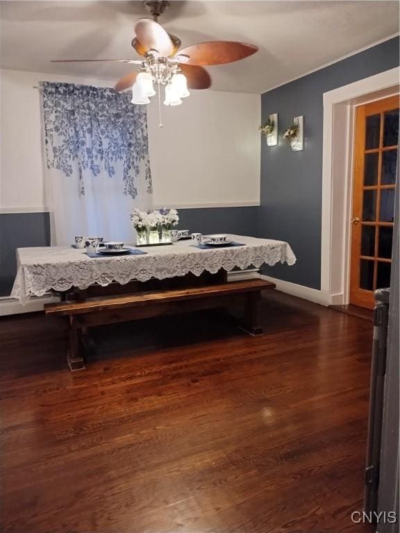 dining room featuring dark wood-style flooring and baseboards