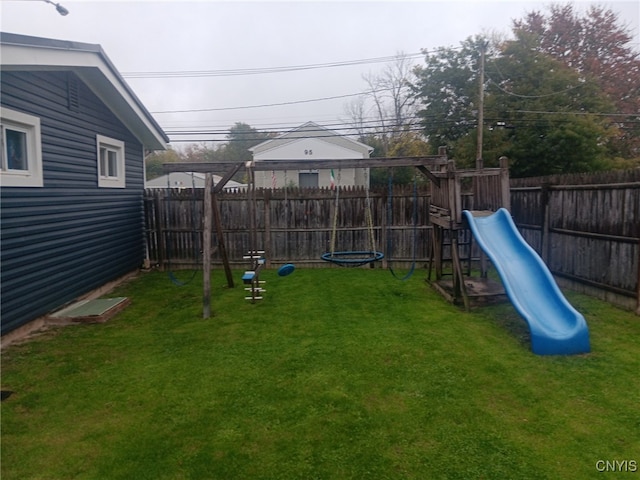 view of jungle gym with a fenced backyard and a lawn