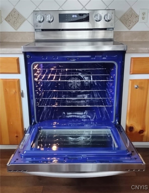 room details with light countertops and stainless steel electric stove