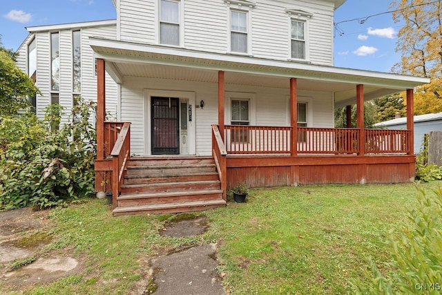 view of front of home with covered porch and a front lawn