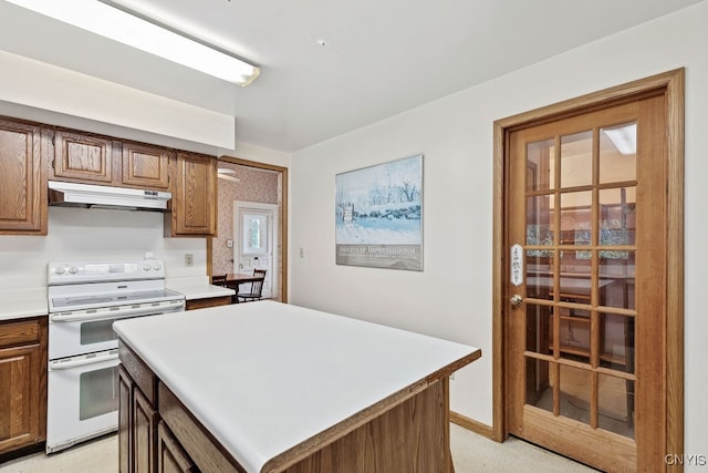 kitchen with white electric range and a kitchen island