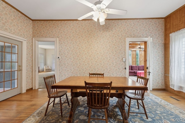 dining area featuring crown molding, hardwood / wood-style flooring, and ceiling fan