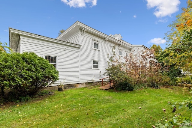 view of home's exterior with a lawn