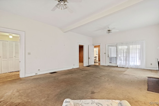 unfurnished living room with beam ceiling, carpet flooring, and ceiling fan