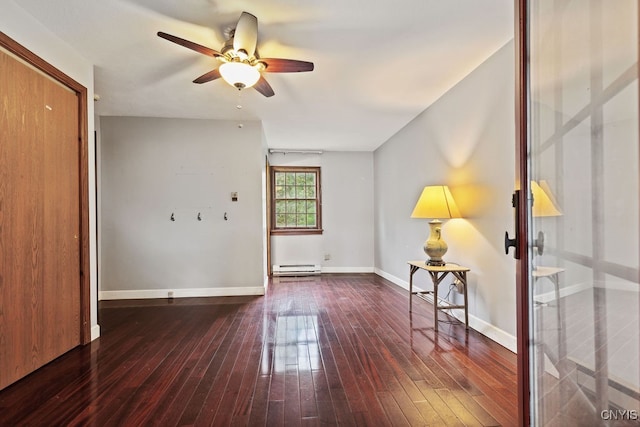 unfurnished room featuring baseboard heating, dark wood-type flooring, and ceiling fan