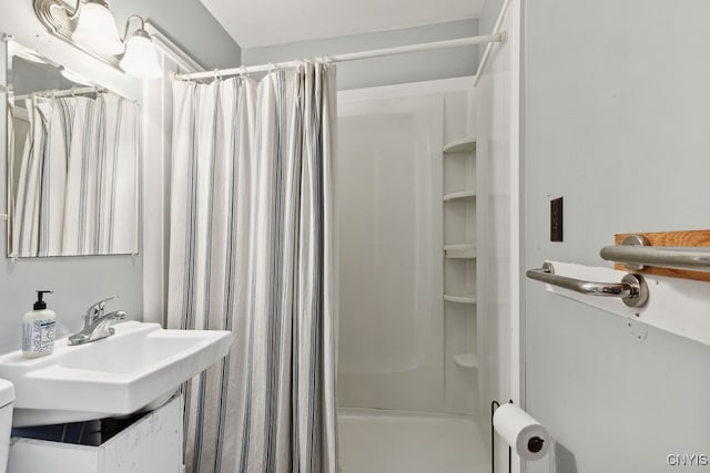 bathroom featuring sink and curtained shower